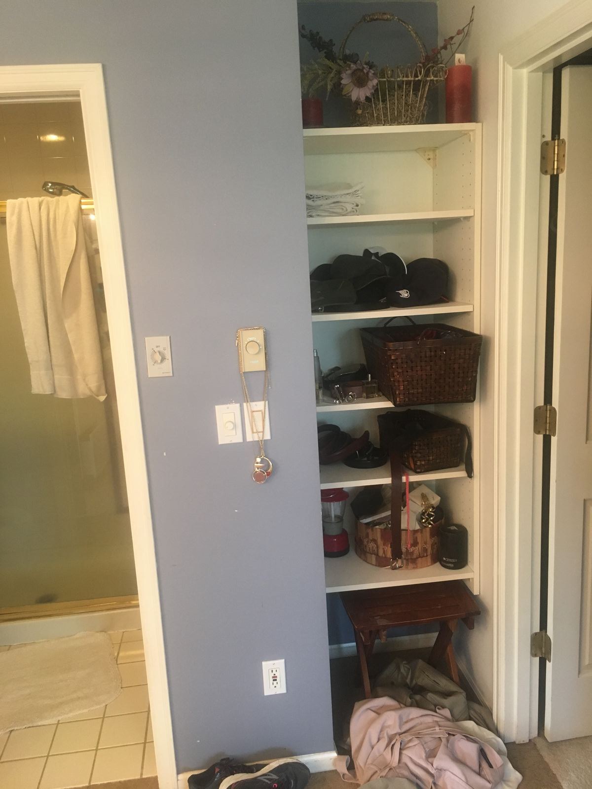Original bathroom closet and shelving before remodel