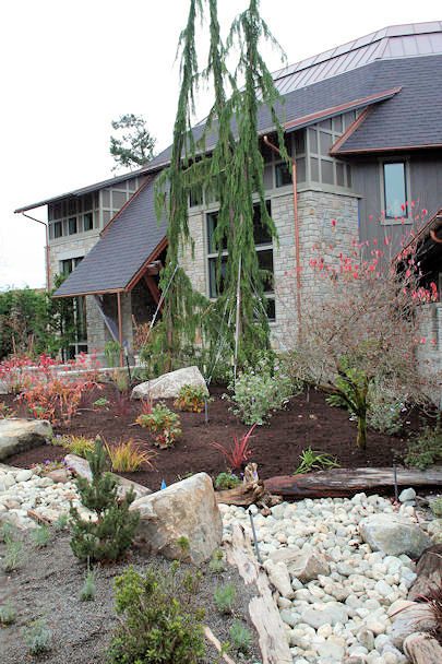 Exterior of the home with stone accents and copper roof detailing