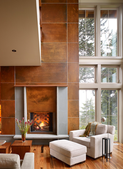 Living room fireplace wall finished in weathered copper panels