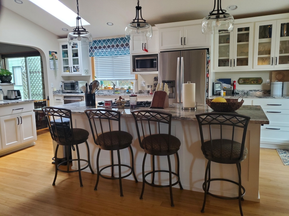 Remodeled open kitchen with island seating and skylight