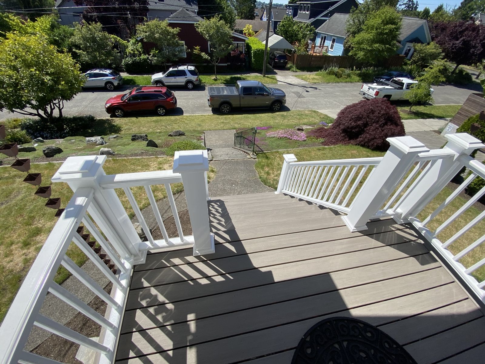 Front entry deck with white painted railings, aerial view